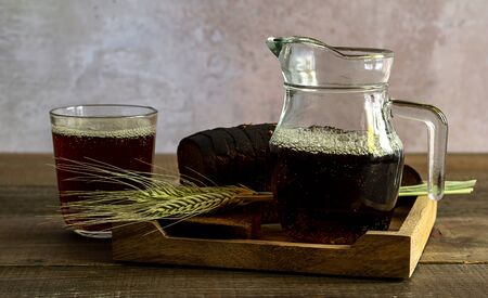 Traditional rye bread kvass in the wooden tray. Selective focus.kvassの写真素材