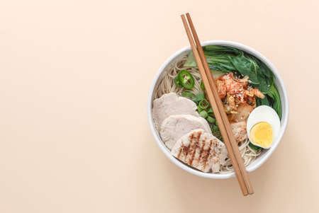 Miso Ramen Asian noodles with egg, chicken, and pak choi cabbage in bowl. Japanese cuisine. Top view, copy space for recipe or text.の写真素材