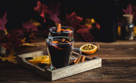 Cozy autumn drink. Hot mulled wine with oranges and spices. seasonal alcohol beverage, copy space.の写真素材