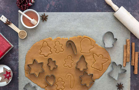 flat lay with cut raw dough for Christmas gingerbread cookies baking. new year preparation, copy space.の写真素材