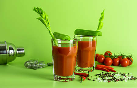 Top view of tomato Bloody Mary cocktail drink with fresh celery, pickles, olives, and lime.の写真素材