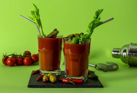 Top view of tomato Bloody Mary cocktail drink with fresh celery, pickles, olives, and lime.の写真素材