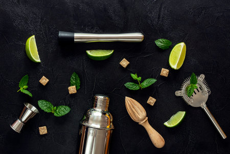 Ingredients for mojito cocktail and tools on a dark table. View from above, copy space