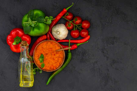 Traditional autumn Balkan vegan spread Ajvar or Aivar with ingredients. Homemade relish. Top view, copy spaceの写真素材