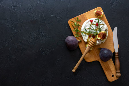 Mouthwatering oven baked Camembert with berries, honey, and figs.