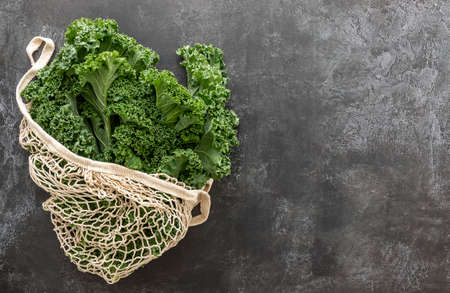 Green kale or leaf cabbage in a string bag. A great source for vitamins K and D also contains Ca. good for cooking stew or chips or smoothie.の写真素材
