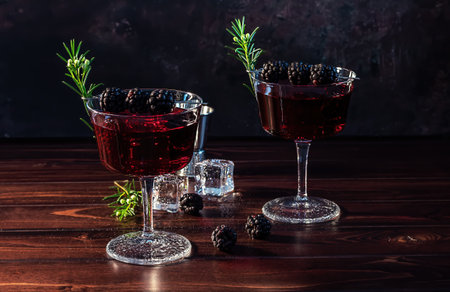 Blackberry Bramble with fresh muddled blackberries, gin, lemon juice, and soda water. Refreshing summer cocktail with ice.の写真素材