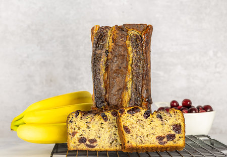 Healthy baking, moisture banana bread with cranberries. Homemade sweets, without artificial sugar, gluten-free recipe. copy spaceの写真素材