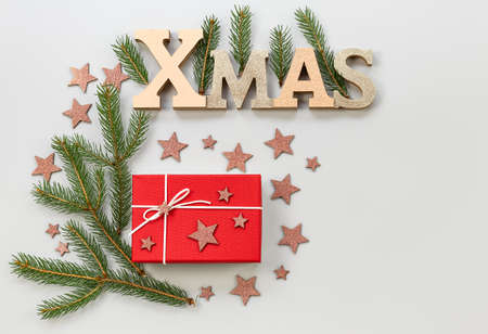 Christmas composition. Holidays postcard with decorative stars, fir tree branches, and gifts. Xmas concept, flat lay, copy space.の写真素材