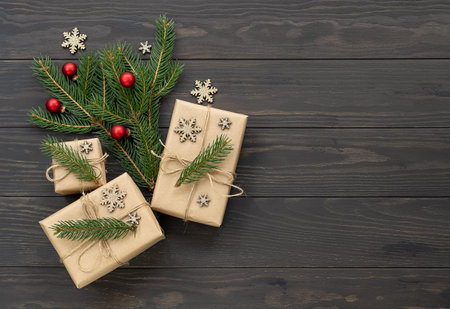 Winter Holiday composition. Wrapped gifts, fir tree branches, and decorative snowflakes and balls on...