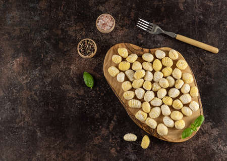 Top view of homemade italian gnocchi made from potatoes, wheat flour dough, eggs. Raw food, prepare to cook. flat lay, copy space for recipe or text.の写真素材
