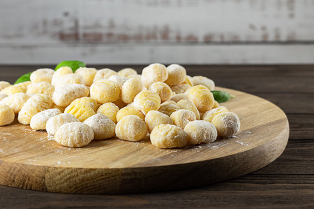 Homemade Italian gnocchi made from potatoes, wheat flour dough, eggs. Raw food, prepare to cook. Copy space for the recipe. shallow depth of field.の写真素材