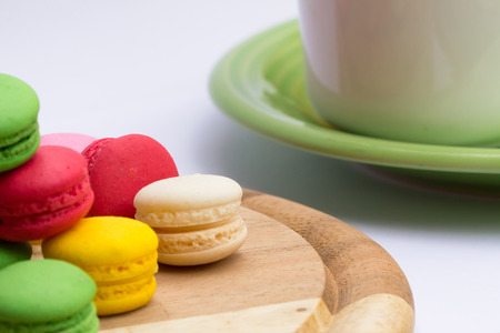 colorful macarons in a cup of tea with white backgroundの写真素材