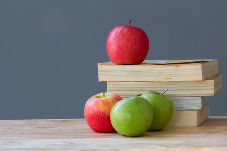 apples with stack of book on wood tableの写真素材