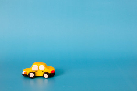 yellow car modeling clay on blue backgroundの写真素材