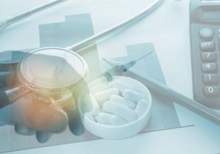 A medical stethoscope ,pills,vaccine and syringe ,medical purchasing and health insurance business conceptの写真素材