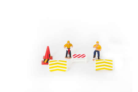 small figure worker on white background with under construction conceptの写真素材