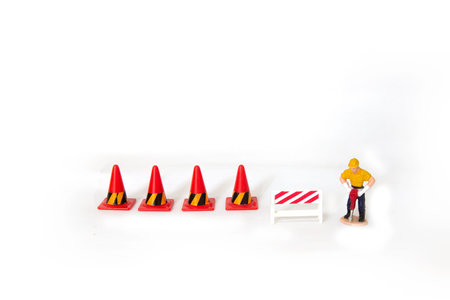 small figures worker work on road with work in progress concept