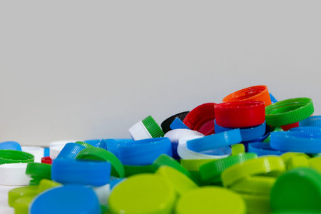 pile of plastic bottle caps , recycle and reduce plastic concept