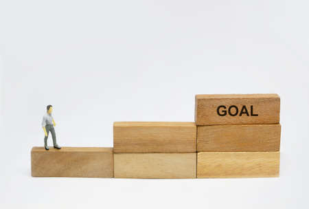 figure of smart man at first step on stairway to successの写真素材