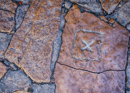X mark carved in stone pavement.の写真素材
