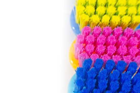 Close up of colorful professional soft toothbrushes with lot of bristles in straight cut on white...