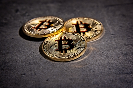 Shining metal BTC bitcoin coins on grey background.の写真素材