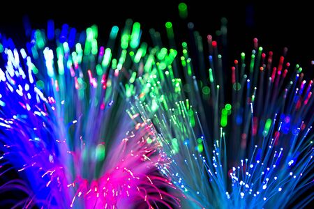Blured bright and dark colorful background - selective focus photo of fiber optics led light.の写真素材