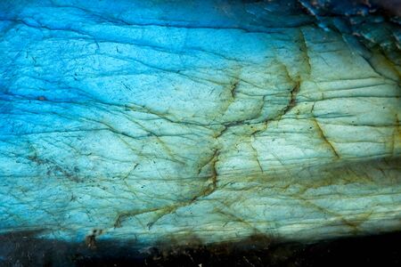 Full frame of green blue and yellow Labradorite crystal stone surface background.の写真素材