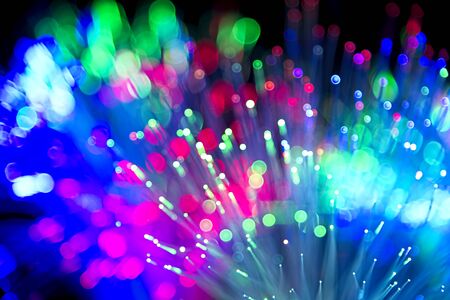 Blured bright and dark colorful background - selective focus photo of fiber optics led light.の写真素材