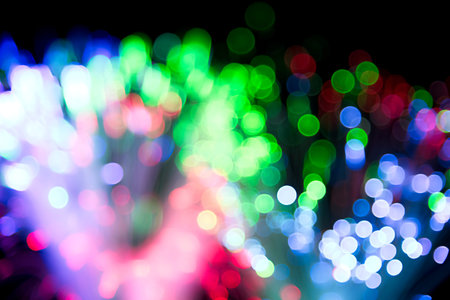 Blured bright and dark colorful background - selective focus photo of fiber optics led light.