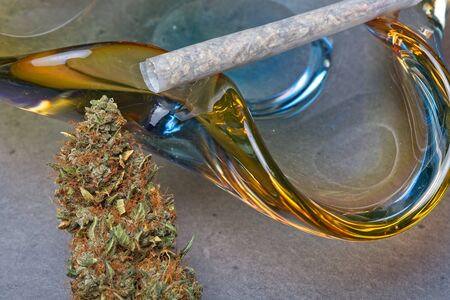 Close up of cannabis - marijuana bud and accessories - glass ashtray and rolled joint - splif.の写真素材