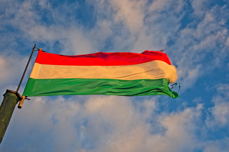 Hungarian flag waving in a wind in evening sun.の写真素材