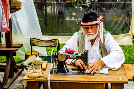 Old tailor on The European Folk and Crafts Festival in Kezmarok - Slovakiaのeditorial素材