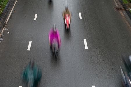 Blurred crowd of different people are walking in the city. Defocused background of city lifeの写真素材