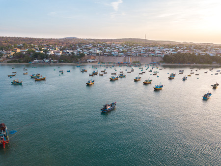 Top view, aerial view fishing harbor market from drone. Mui Ne harbor fishing or fishing village. Fishing harbor is a popular tourist destinationの写真素材