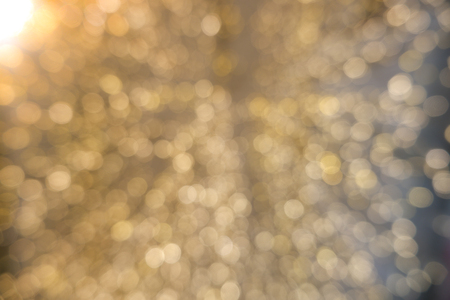Abstract yellow bokeh circles for Christmas background. Royalty high-quality free stock photo of Christmas light overlay background. Holiday glowing backdrop. Defocused background with blinking starsの写真素材