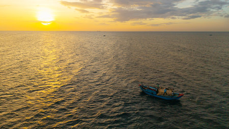 Morning lifestyle of fishermen at sea. High-quality free stock of tropical sunrise with golden light, traditional culture, scenic travel destinationの写真素材