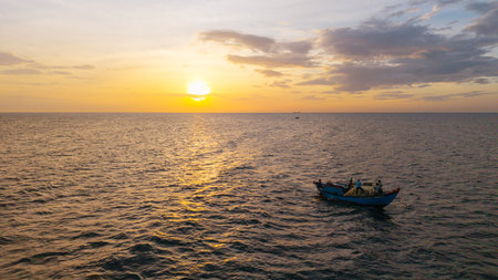 Morning lifestyle of fishermen at sea. High-quality free stock of tropical sunrise with golden light, traditional culture, scenic travel destinationの写真素材