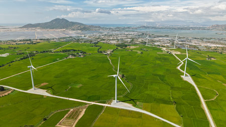 Green rice fields with wind turbines in rural Ninh Thuan, Vietnam. High-quality stock of renewable...