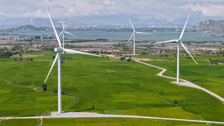 Green rice fields with wind turbines in rural Ninh Thuan, Vietnam. High-quality stock of renewable...