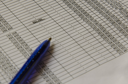 Close-up of financesand pen on office table.の写真素材