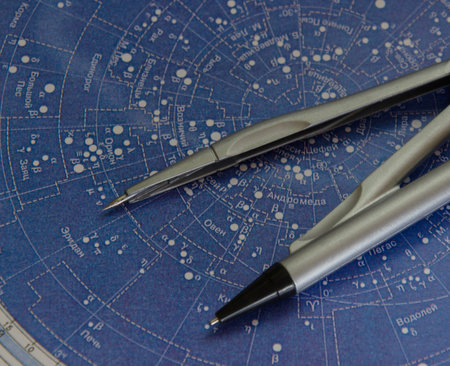Compasses on the blue paper star mapの写真素材