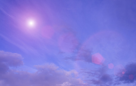 Beautiful purple sky and sun with cloudsの写真素材