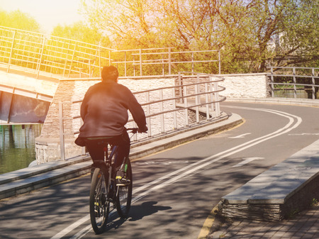 A man is riding on the bicycle in the parkの写真素材