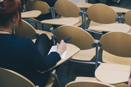 Young woman sitting on the conference in officeの写真素材