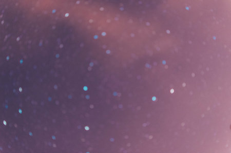 Blurred defocused photo with bokeh of the night sky with startsの写真素材