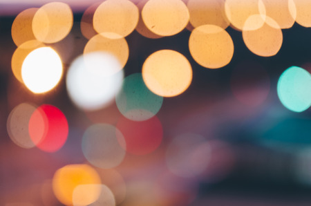 city lights abstract circular bokeh on evening sky backgroundの写真素材