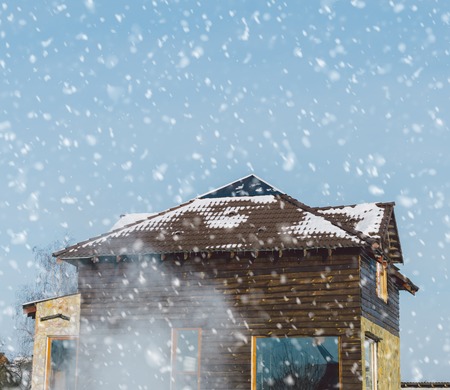 Wood house in village in snowfall timeの写真素材