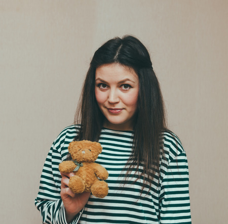 Young beautiful girl and her teddy bearの写真素材